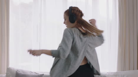 happy-woman-dancing-at-home-having-fun-listening-to-music-wearing-headphones-enjoying-weekend-celebration-with-funny-dance-moves