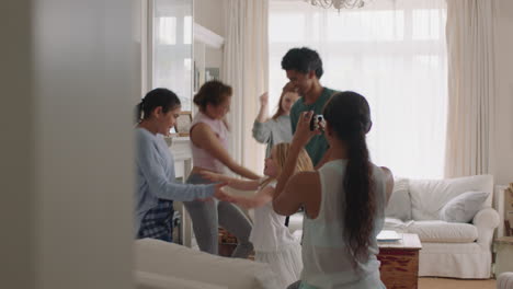 happy-multi-ethnic-family-dancing-at-home-having-fun-enjoying-dance-celebration-teenage-girl-using-smartphone-sharing-video-of-exciting-weekend-on-social-media