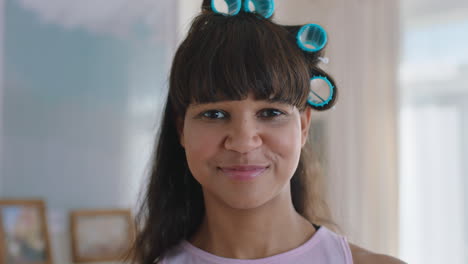 portrait-funny-teenage-girl-wearing-hair-curlers-smiling-happy-teenager-at-home-teen-self-image-concept-4k-footage