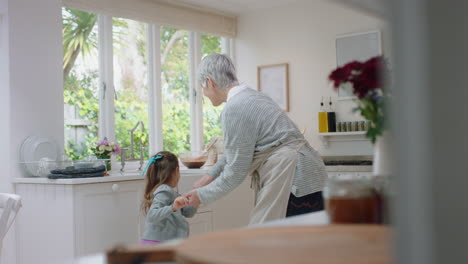 happy-grandmother-dancing-with-little-girl-in-kitchen-granny-having-fun-dance-with-granddaughter-celebrating-family-weekend-at-home