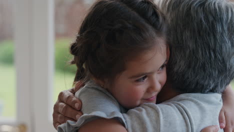 happy-girl-greeting-grandmother-with-hug-granny-smiling-embracing-her-granddaughter-enjoying-hug-from-grandchild-at-home-family-concept-4k