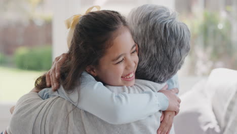 happy-girl-greeting-grandmother-with-hug-granny-smiling-embracing-her-granddaughter-enjoying-hug-from-grandchild-at-home-family-concept-4k