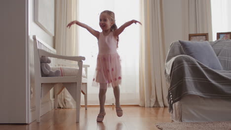 cute-little-girl-dancing-playfully-pretending-to-be-ballerina-happy-child-having-fun-playing-dress-up-wearing-ballet-costume-with-fairy-wings-at-home-4k