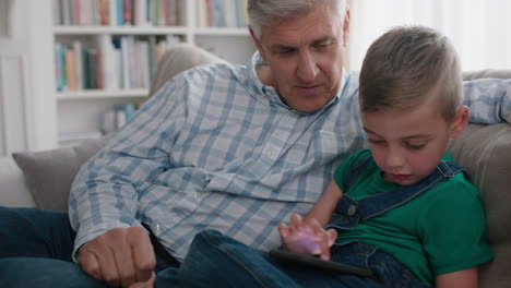 happy-grandfather-showing-little-boy-how-to-use-smartphone-teaching-curious-grandson-modern-technology-intelligent-child-learning-mobile-phone-sitting-with-grandpa-on-sofa