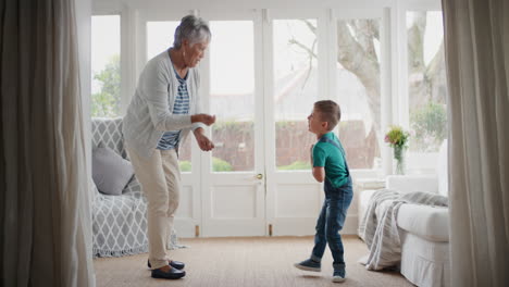 happy-little-boy-dancing-with-grandmother-funny-granny-having-fun-dance-with-grandson-celebrating-family-weekend-at-home