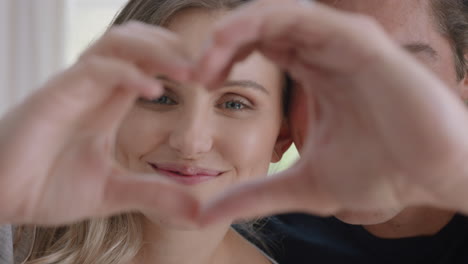 happy-couple-making-heart-shape-with-hands-gesturing-romantic-commitment-enjoying-loving-relationship-on-valentines-day-4k-footage