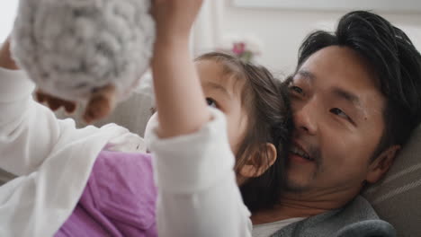 asian-father-and-daughter-having-family-time-little-girl-playing-with-teddy-bear-toy-at-home-relaxing-with-dad-4k