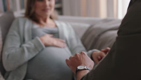 young-pregnant-woman-going-into-labor-having-contractions-nervous-husband-helping-wife-breath-calmly-through-pregnancy-pain-relaxing-on-sofa-at-home