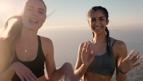 funny-girl-friends-dancing-on-mountain-top-celebrating-successful-hiking-adventure-with-victory-dance