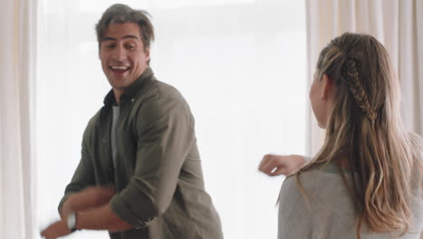 happy-young-couple-dancing-together-at-home-celebrating-having-fun-weekend-smiling-enjoying-funny-dance-in-living-room-successful-relationship-celebration-4k-footage