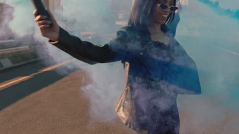 girl-dancing-with-blue-smoke-grenade-in-city-young-rebellious-woman-celebrating-creative-expression-with-dance-in-street-slow-motion