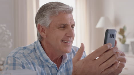 happy-mature-man-having-video-chat-using-smartphone-grandfather-enjoying-conversation-with-family-sharing-lifestyle-chatting-on-mobile-phone-relaxing-at-home-4k
