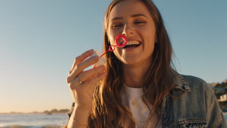 teenage-girl-blowing-bubbles-on-beach-at-sunset-having-fun-on-vacation-by-the-sea-enjoying-summer