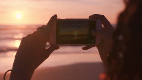 close-up-young-woman-on-beach-using-smartphone-taking-photo-of-beautiful-sunset-enjoying-sharing-summer-vacation-travel-experience-on-social-meda