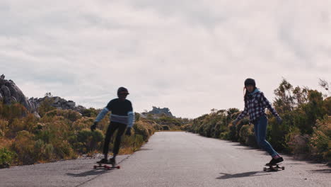 Glückliche-Freunde-Longboarding-Freunde-High-Five-Fahren-Gemeinsam-Skateboard-Und-Machen-Tricks-Auf-Der-Landstraße-Und-Genießen-Die-Sommerferien-Beim-Schlittschuhlaufen-Mit-Schutzhelm