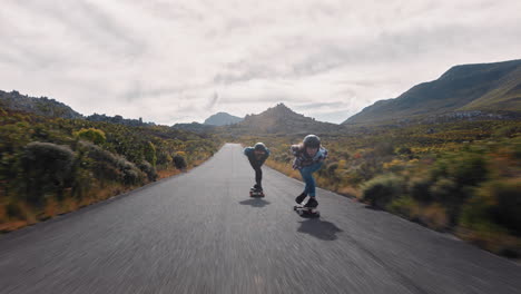 young-woman-longboarding-overtaking-in-competitive-race-cruising-on-countryside-road-friends-skating-together-riding-skateboard-wearing-protective-helmet