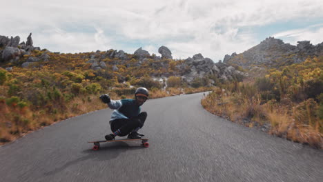 young-african-american-man-riding-longboard-skating-fast-enjoying-cruising-downhill-on-countryside-road-doing-tricks-using-skateboard-slow-motion