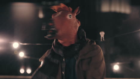 funny-man-wearing-horse-mask-dancing-in-rain-on-rooftop-having-fun-performing-silly-dance-moves-celebrating-weekend