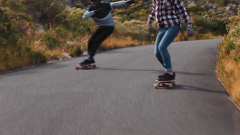 happy-multi-ethnic-friends-longboarding-together-cruising-fast-racing-having-fun-riding-on-countryside-road-skateboarding-wearing-protective-helmet-summer-vacation-sport