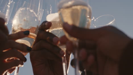 close-up-happy-group-of-friends-making-toast-drinking-champagne-celebrating-rooftop-party-enjoying-diverse-reunion-celebration-on-weekend-social-gathering-at-sunset