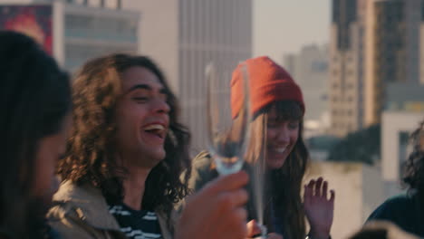 young-man-popping-cork-pouring-champagne-happy-group-of-friends-celebrating-on-rooftop-having-fun-celebrating-summer-vacation-at-sunset
