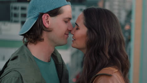 beautiful-caucasian-couple-kissing-on-rooftop-summer-romance-sharing-intimate-connection-hanging-out-on-roof-at-sunet
