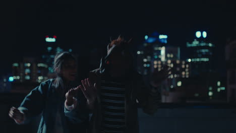 funny-man-wearing-horse-mask-dancing-with-friends-on-rooftop-having-fun-performing-silly-dance-moves-celebrating-weekend-together-in-urban-city-skyline