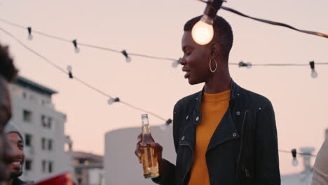 beautiful-african-american-woman-enjoying-rooftop-party-celebration-chatting-to-friends-socializing-drinking-alcohol-sharing-celebration-at-sunset