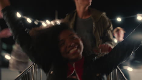 beautiful-african-american-woman-having-fun-sitting-in-shopping-cart-group-of-friends-enjoying-crazy-rooftop-party-at-night-playfully-celebrating-weekend-drinking