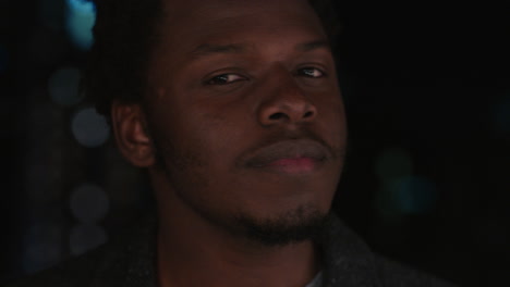 portrait-handsome-african-american-man-on-rooftop-at-night-drinking-alcohol-smiling-happy-enjoying-urban-nightlife-with-bokeh-city-lights-in-background
