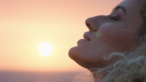 close-up-portrait-of-beautiful-woman-enjoying-peaceful-seaside-at-sunset-contemplating-journey-exploring-spirituality-feeling-freedom-with-wind-blowing-hair