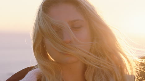 portrait-of-happy-woman-laughing-having-fun-on-summer-vacation-enjoying-seaside-at-sunset-with-wind-blowing-hair