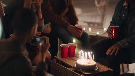 happy-group-of-friends-celebrating-birthday-party-on-rooftop-at-night-beautiful-young-woman-blowing-candles-enjoying-friendship-having-fun-sharing-celebration