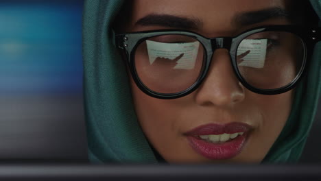 close-up-portrait-beautiful-muslim-business-woman-using-tablet-computer-working-late-browsing-internet-brainstorming-looking-at-information-on-screen-wearing-glasses
