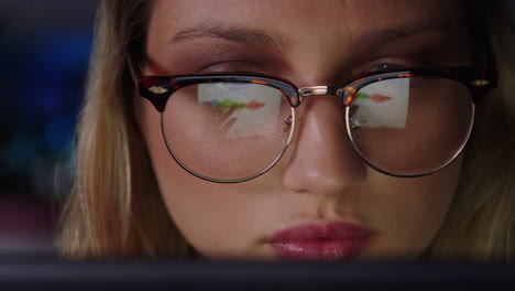 close-up-portrait-beautiful-caucasian-business-woman-working-late-using-tablet-computer-browsing-financial-graph-data-looking-at-information-on-screen-wearing-glasses