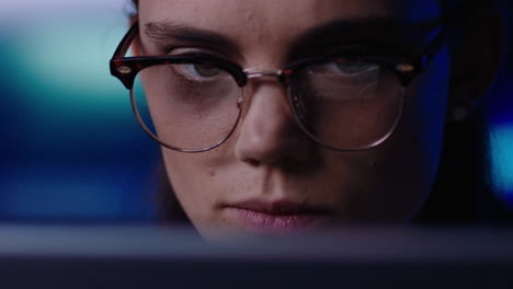 close-up-portrait-young-business-woman-working-late-using-tablet-computer-browsing-financial-graph-data-looking-at-information-on-screen-wearing-glasses