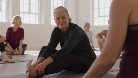 Clase-De-Yoga-Anciana-Feliz-Charlando-Con-El-Instructor-Discutiendo-Entrenamiento-Físico-Saludable-Disfrutando-Del-Entrenamiento-Grupal-En-El-Estudio-De-Entrenamiento