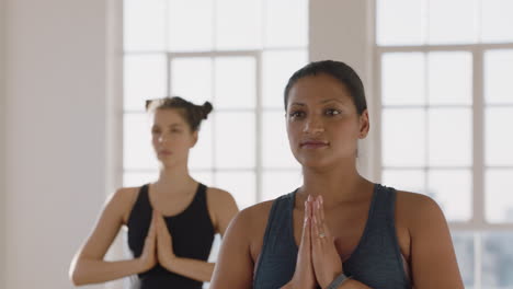 young-pregnant-mixed-race-woman-in-yoga-class-practicing-warrior-pose-enjoying-healthy-lifestyle-group-exercising-in-fitness-studio-at-sunrise