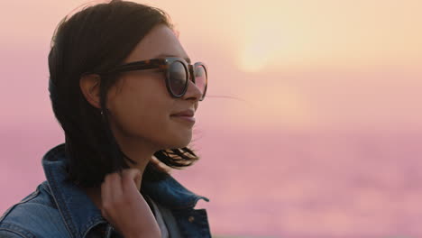 portrait-of-beautiful-asian-woman-smiling-enjoying-carefree-lifestyle-exploring-freedom-on-vacation-looking-happy-with-wind-blowing-hair-wearing-sunglasses