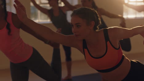 yoga-class-young-healthy-woman-practicing-lord-of-the-dance-pose-enjoying-exercising-in-fitness-studio-with-multiracial-group-of-people-at-sunrise