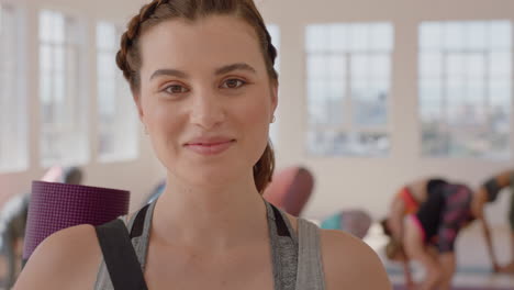 yoga-class-portrait-of-happy-caucasian-woman-smiling-confidently-enjoying-healthy-lifestyle-with-multi-ethnic-people-practicing-in-fitness-studio-background