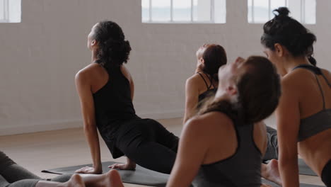 yoga-class-group-of-multiracial-women-practicing-cobra-pose-enjoying-healthy-lifestyle-exercising-in-fitness-studio-at-sunrise