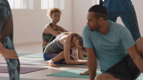 yoga-class-group-of-multiracial-people-stretching-ready-for-early-morning-workout-in-fitness-studio-at-sunrise