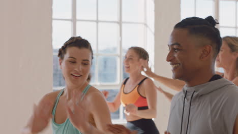 happy-caucasian-woman-dancing-group-of-healthy-people-enjoying-workout-practicing-choreography-dance-moves-having-fun-in-lively-fitness-studio
