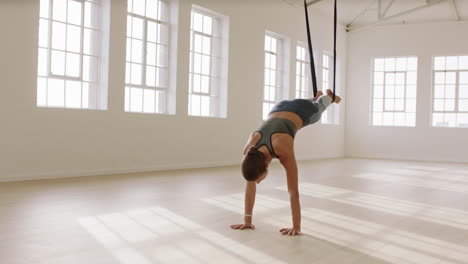 fit-aerial-yoga-woman-practicing-poses-using-hammock-enjoying-fitness-lifestyle-exercising-in-studio-training-meditation-at-sunrise