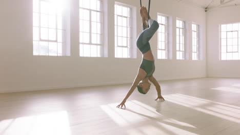 aerial-yoga-woman-practicing-monkey-pose-hanging-upside-down-using-hammock-enjoying-healthy-fitness-lifestyle-exercising-in-studio-training-meditation-at-sunrise