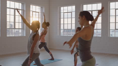 yoga-class-of-healthy-women-practicing-reverse-warrior-pose-enjoying-exercising-in-fitness-studio-instructor-leading-group-meditation-teaching-workout-posture-at-sunrise
