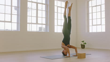 beautiful-yoga-woman-practicing-headstand-pose-enjoying-fitness-lifestyle-exercising-in-studio-stretching-flexible-body-training-early-morning-meditation-on-exercise-mat