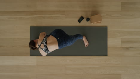 above-view-yoga-woman-practicing-intense-side-stretch-pose-in-workout-studio-enjoying-healthy-lifestyle-meditation-practice-training-on-exercise-mat