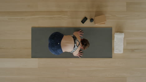 above-view-yoga-woman-practicing-lotus-forward-bend-pose-in-workout-studio-enjoying-healthy-lifestyle-meditation-practice-training-on-exercise-mat
